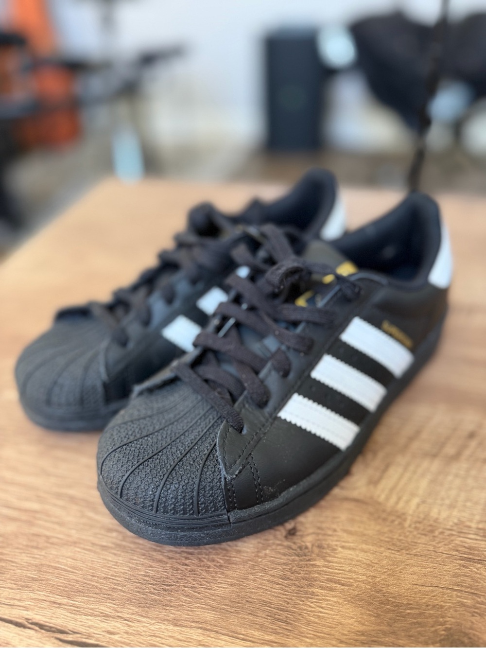adidas Black Sneakers with White Stripes and Gold Accent